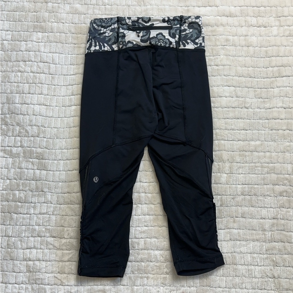 Black lululemon capri leggings with white floral print. Size 2